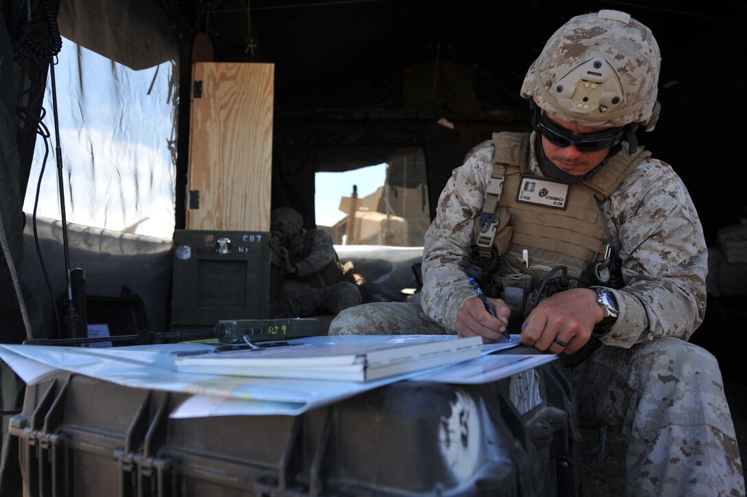 Capt. Todd Eyesenbach marks airstrike locations on a map of this island Aug 13. Eyesenbach is the officer in charge of a detachment from 1st Air Naval Gunfire Liaison Company attached to the 11th Marine Expeditionary Unit. His teams participated in close-air-support training Aug. 12-13.